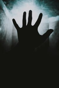 Eine ausgestreckte Hand erhebt sich dramatisch gegen einen nebligen Lichtschein, die Szene wirkt beklemmend und mysteriös. Dieses Bild symbolisiert das Gefühl von Überforderung oder innerem Kampf. Gerade bei ADHS Schweiz sind nächtliche Unruhe und emotionale Belastungen häufige Themen.